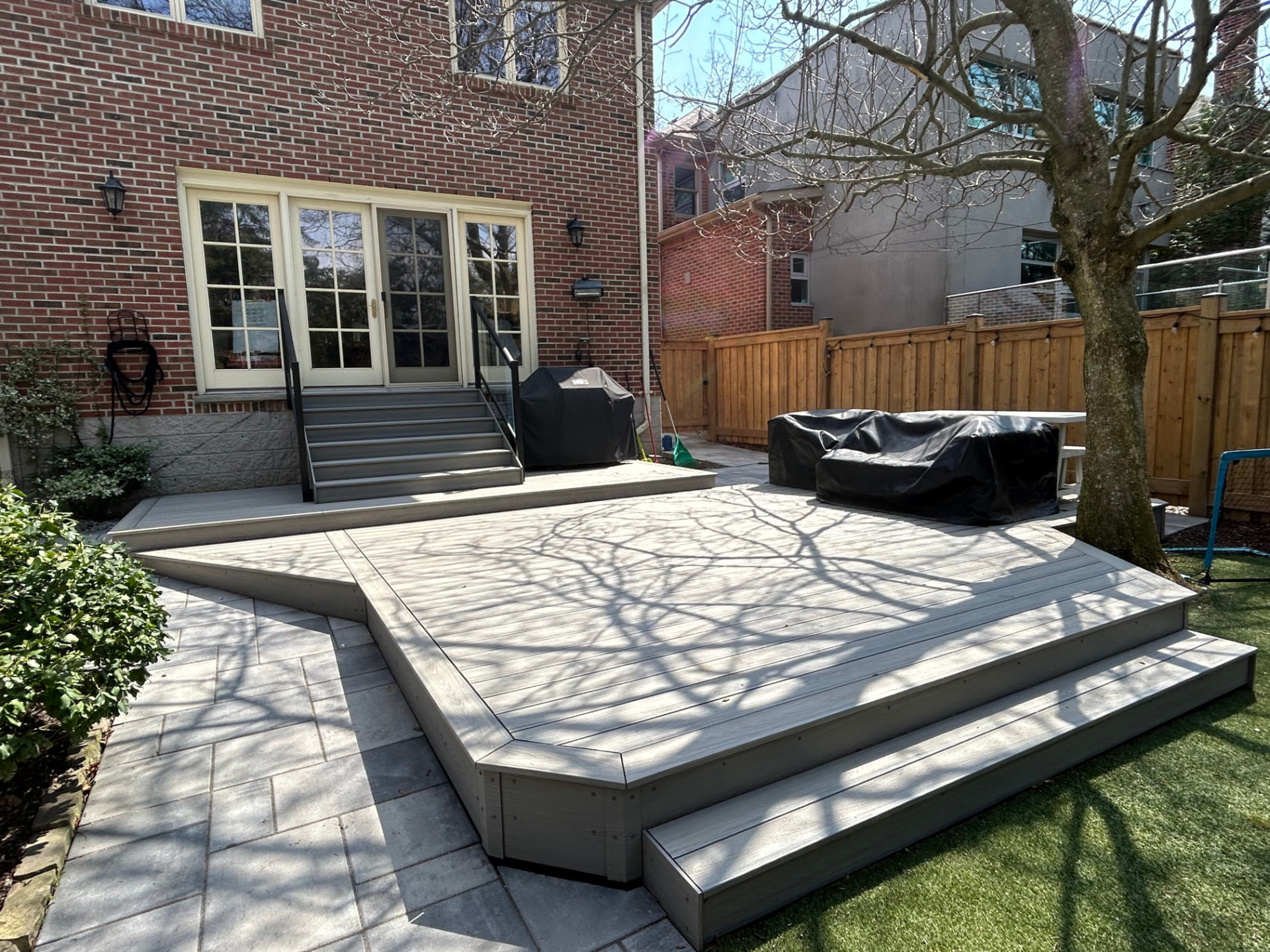 Composite deck & stone patio — completed project